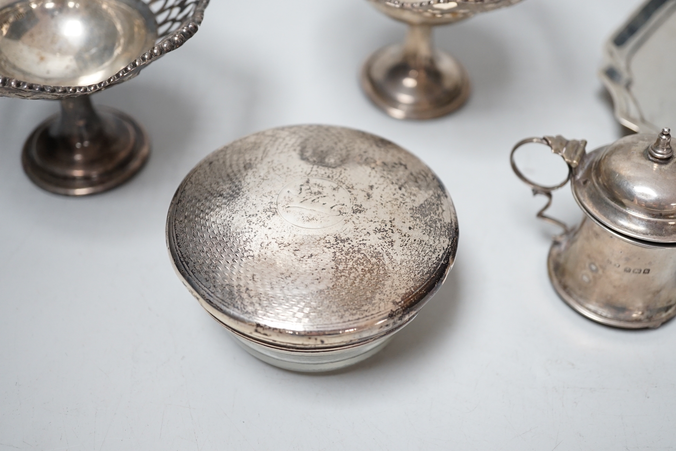 Sundry small silver including a late Victorian silver waiter, Birmingham, 1899, 14.5cm, two silver mounted toilet jars, a silver mustard pot and pair of silver pedestal tazzes.